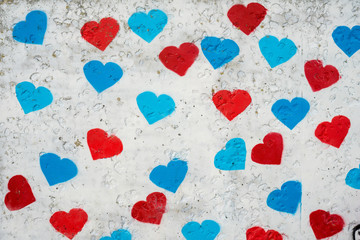 Many heart signs at the wall. Red and blue colors.