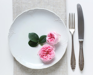 Romantic vintage place setting with pink rose