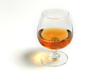 amber whiskey in snifter glass on white background