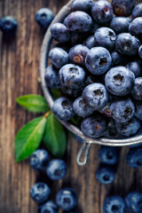 Fresh blueberries from organic cultivation on rustic wooden table, top view