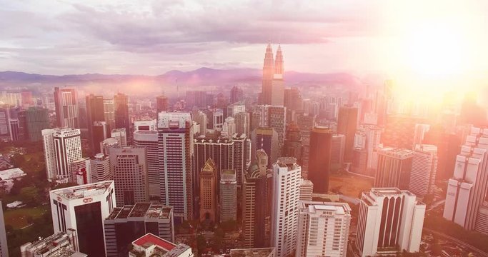Part of the city of Kuala Lumpur and the Petronas Twin Towers or Kuala Lumpur City Centre KLCC as part of the skyline at sunset