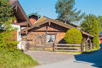 Beautiful authentic one level house surrounded with firewood and wooden fence.