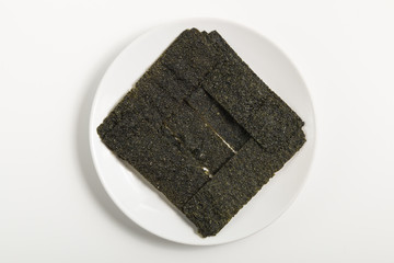thai snack  fried seaweed square decorate in dish on white background