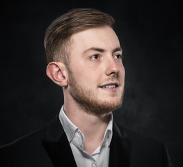 Young handsome man in black suit.