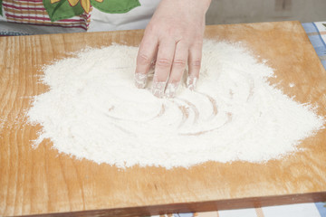 Women's hands preparing flour before baking pie