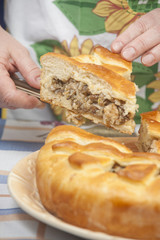 Cutting the tasty pie with filling