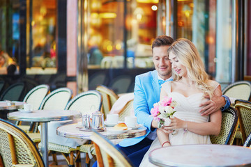 Just married couple in traditional Parisian cafe