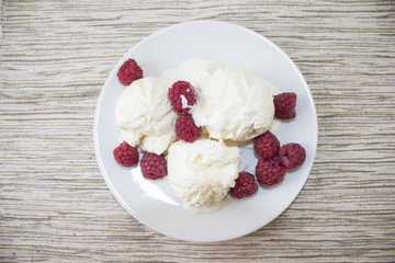 White ice cream with raspberries