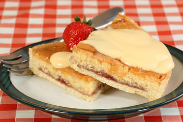 two slices of bakewell tart with custard