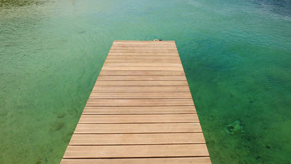 Fototapeta premium View on the wooden catwalk and the crystal emerald water in a lagoon on the island Lobos, Spain.