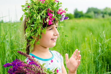 Smiling girl with big bouquet of spring flowers on green grass. Mothers day concept