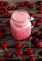 Cherry smoothie in jar glass on wooden table. healthy food concept for breakfast or snack.