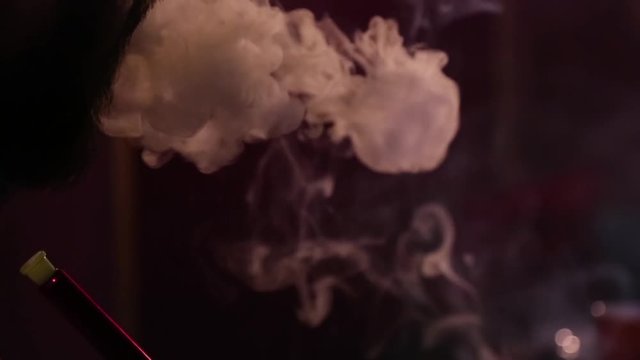 Beard man let the smoke out close up.