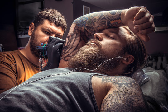 Man wearing gloves posing in tatoo salon