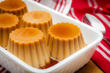 Rustic setup of delicious creme caramel served with sweet syrup, a traditional dessert
