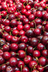 Ripe red cherries in the market on the counter