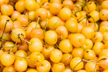 Ripe yellow cherries in the market on the counter