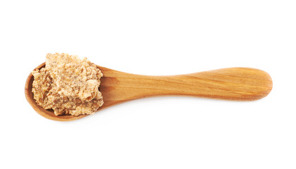 Wooden spoon full of cereal flakes isolated