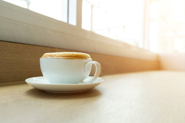 cappuccino coffee cup on wooden table with copy space
