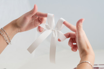 Obraz na płótnie Canvas Ribbon bow gift box handmade craft hand fold stripe decoration manual directions final result isolated