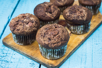 Chocolate muffins on the rustic wooden table. Shallow depth of field.