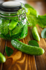 pickled cucumbers with spices in glass jar