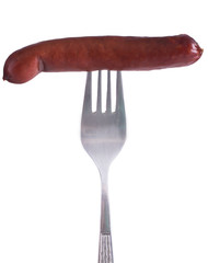 Close-up of fried sausage on a fork. Isolated over white background.