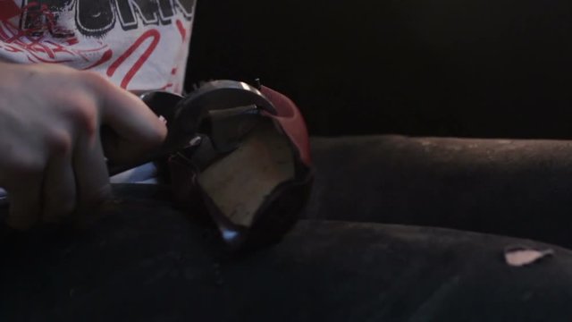 Shoemaker sews shoes. Hammering shoe leather