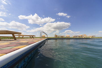 Amazing views over the pool area with wooden sun loungers.