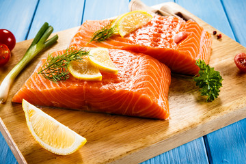 Fresh raw salmon fillets on cutting board