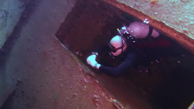 Male scuba diver inside the wreck of the Giannis D, Red Sea, Egypt
