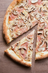 Top view of Italian PIZZA with mushrooms, salami, olives and che