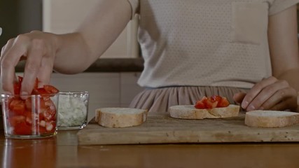 Woman making a fresh bruschetta - Powered by Adobe