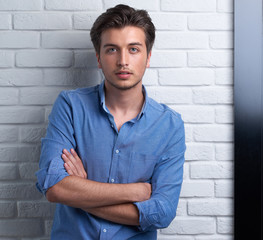 man is staying on the brick background in the studio