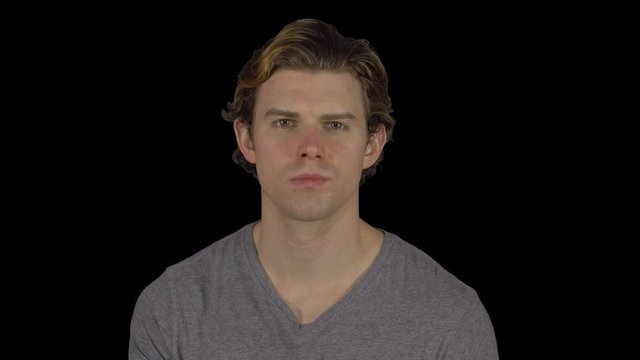 Young guy turns to camera with serious look (Transparent Background)