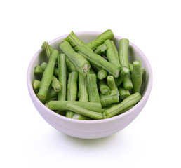 Slices yardlong bean in white bowl isolated on white background.