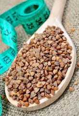 Spoon with buckwheat seeds and centimeter