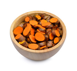 sliced turmeric in wood bowl on white background