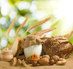 bread, nuts, wheat and dairy on water background
