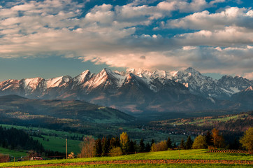 Beautiful spring panorama over Spisz highland to snowy Tatra mountains in the colorful morning, Poland © tomeyk