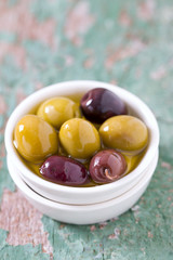 olives in a bowl on wooden surface
