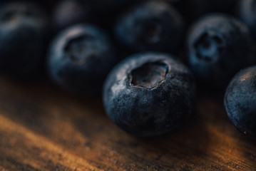 Blueberry pile on wooden table, macro