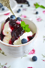 Vanilla ice cream with blueberry jam in a cup