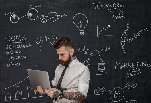 Tattooed Bearded Techer With Laptop.