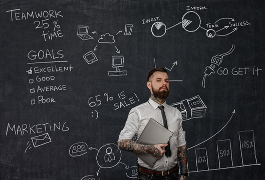 Tattooed Bearded Techer With Laptop.