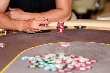 Closeup of hands of poker player with chips on poker table, sele - 115455653