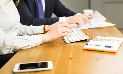 Working on the computer. Close-up of woman typing something