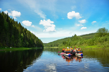 people float down the River on inflatable catamaran