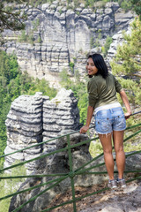 Naklejka premium Woman on the lookout in nature, Bohemian Switzerland