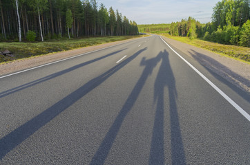 Shadows from a group of people on the highway.